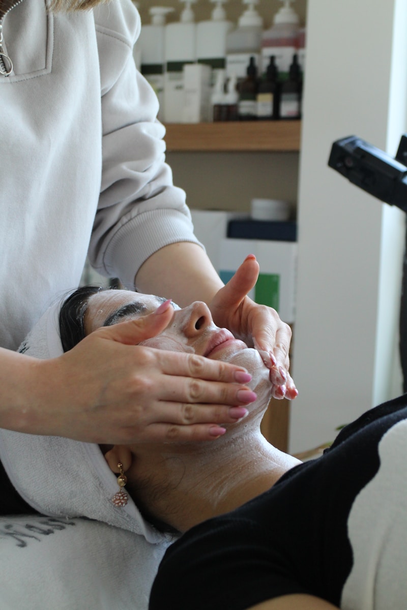 A woman getting a facial mask on her face